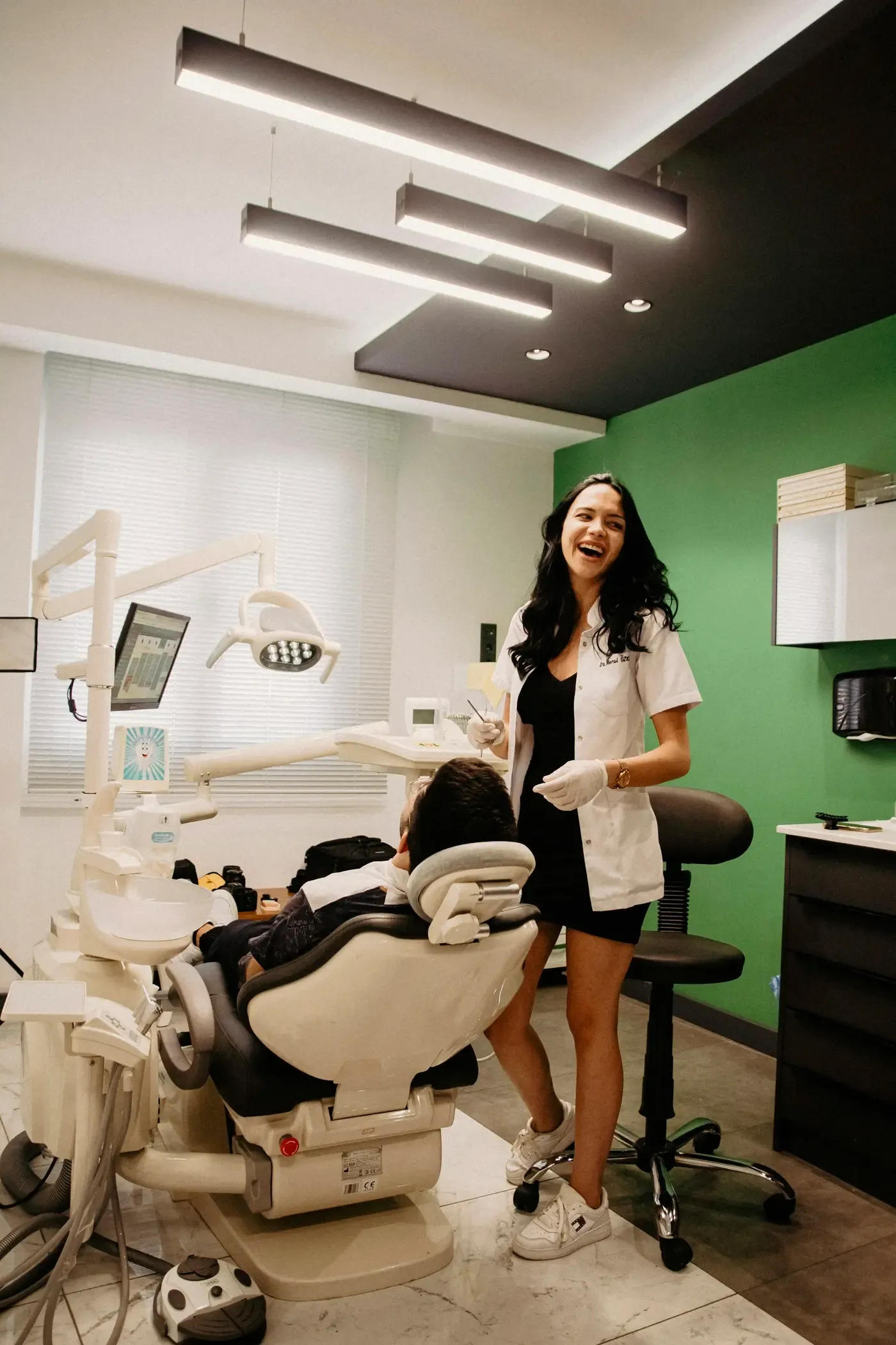 Bright orthodontic treatment room with a smiling clinician