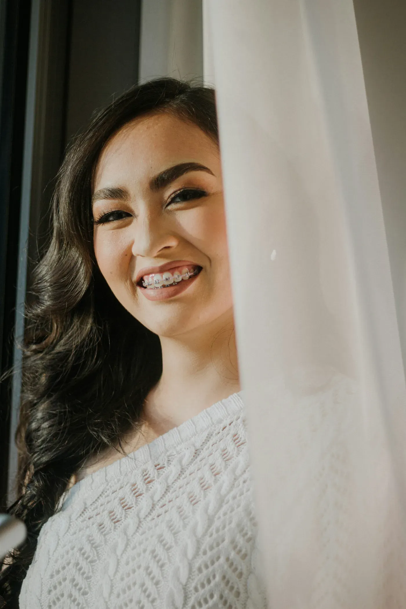 Young woman smiling with braces