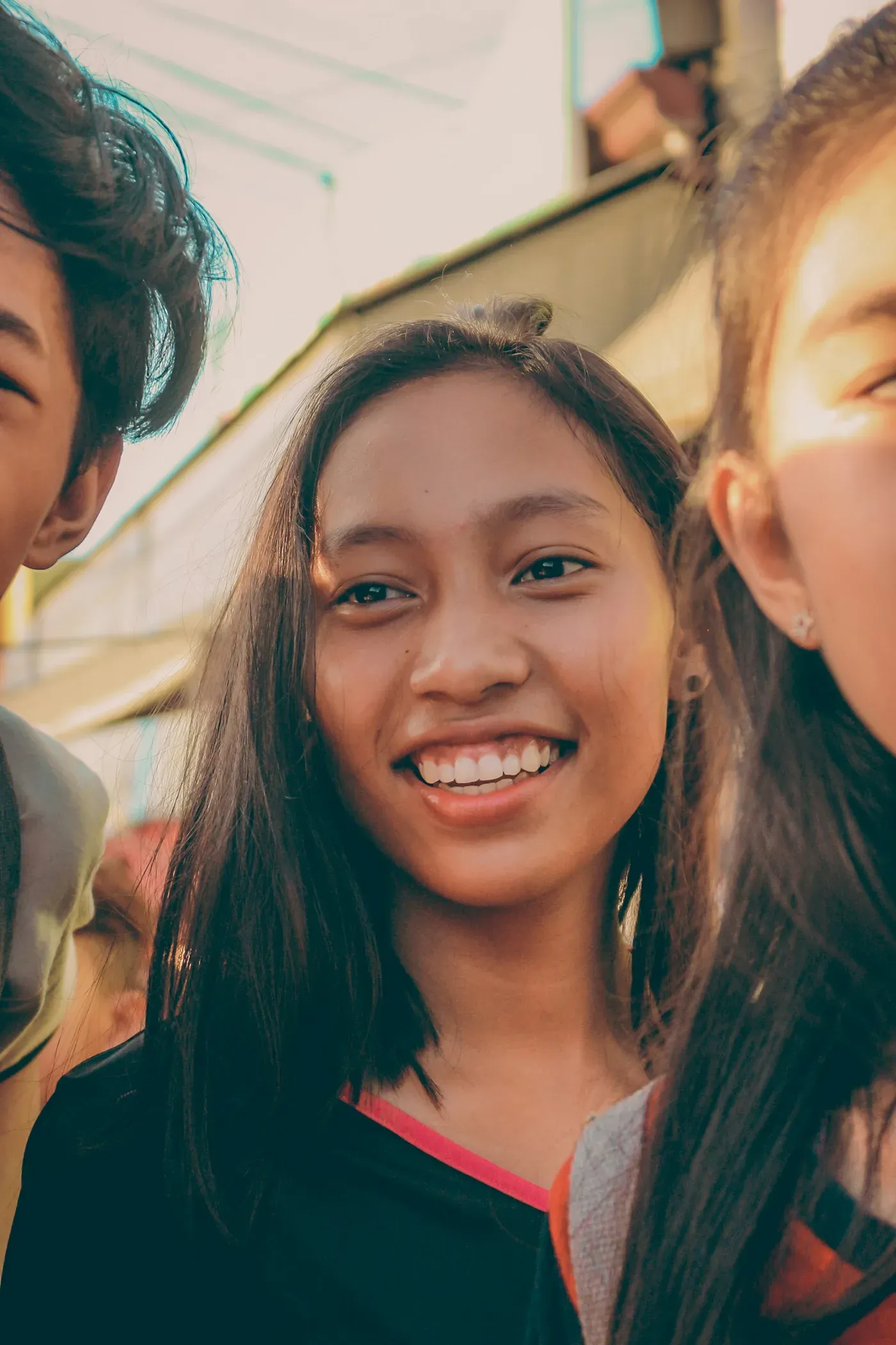 Teen smiling with braces among friends