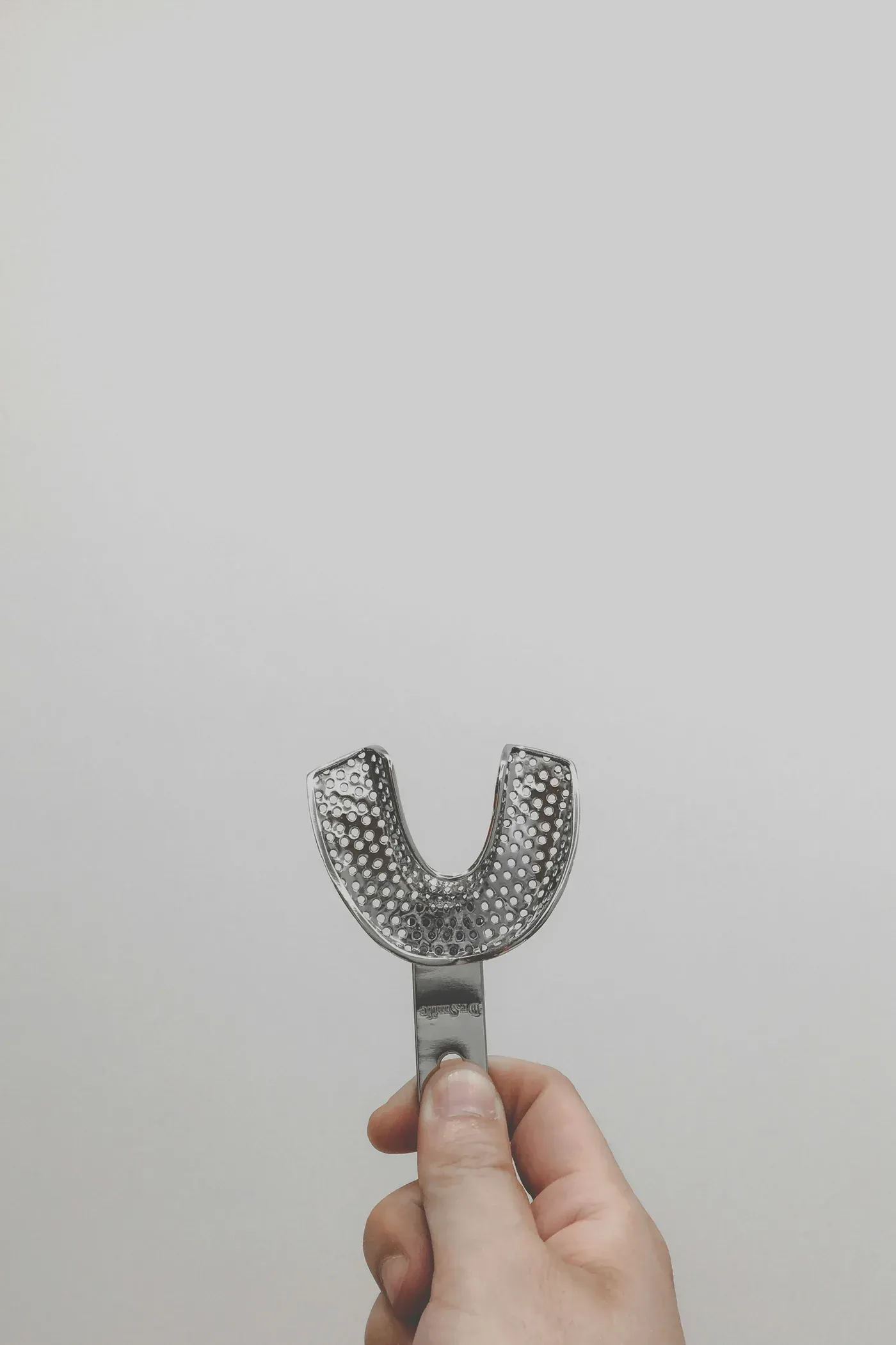 Hand holding a dental tray